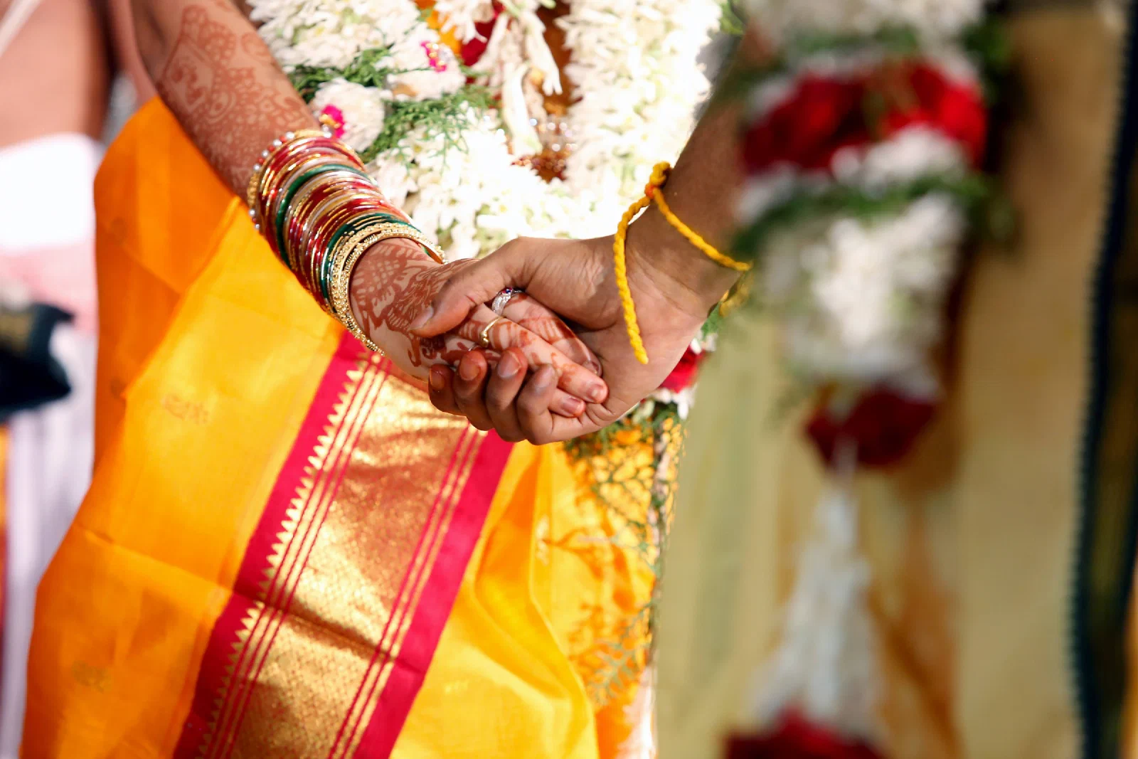 A couple holding hands during a wedding ceremony